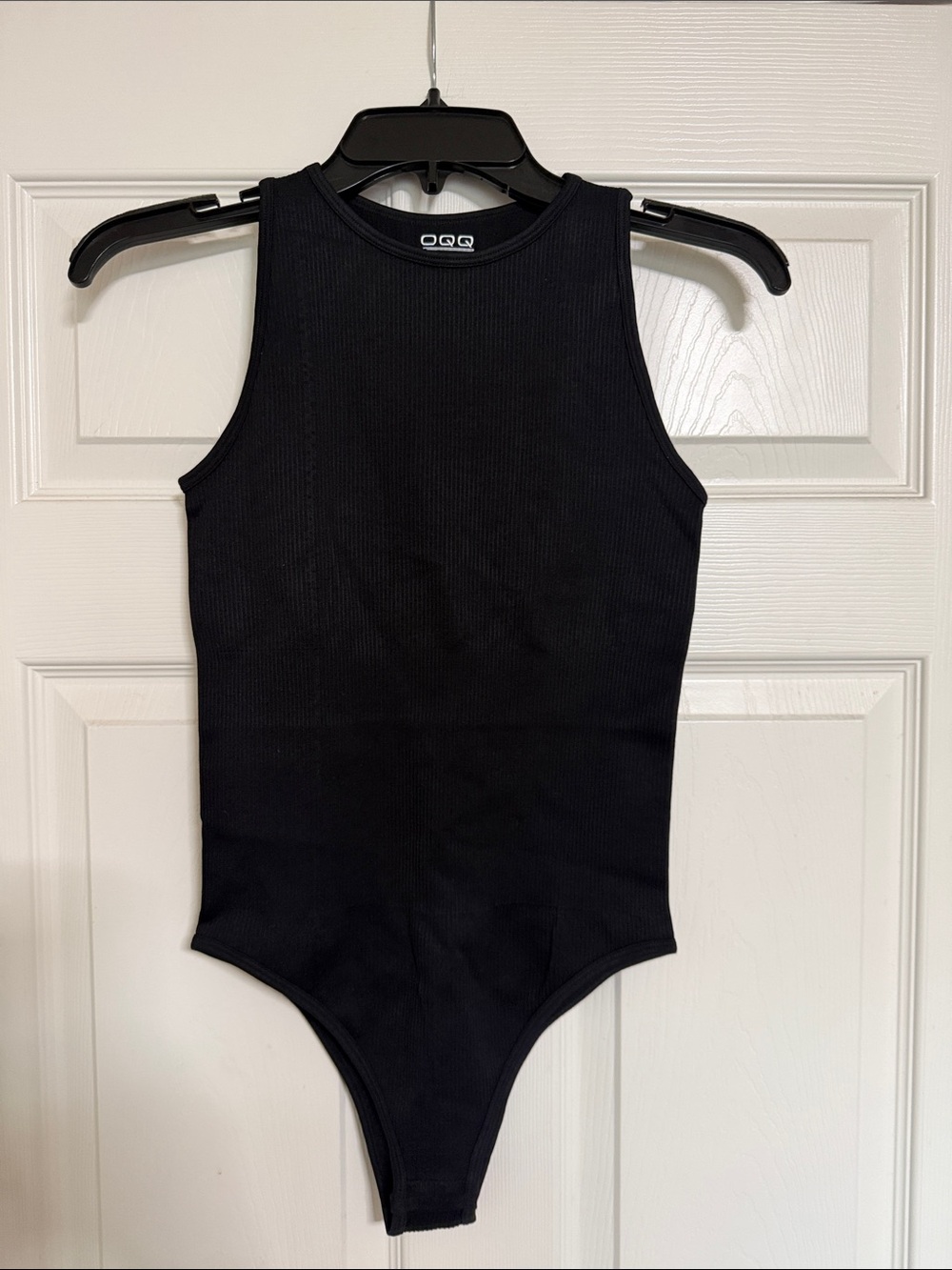 OQQ Woman’s Black Ribbed One-Piece Bodysuit